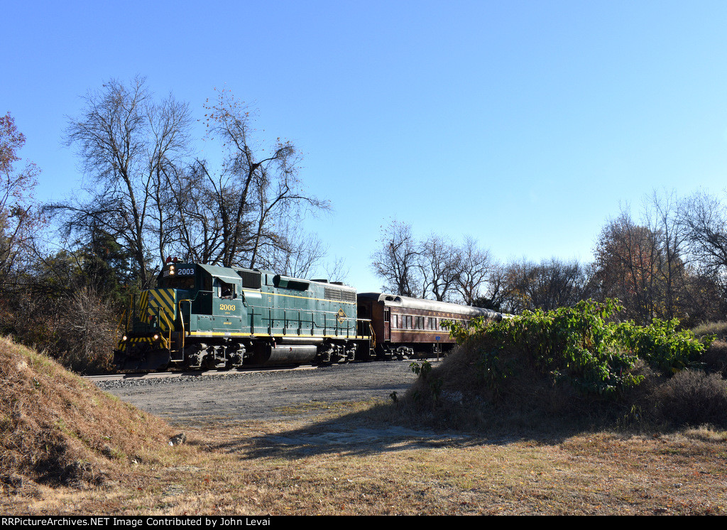 GP38-2 # 2003 sneaks up from behind the woods a little south of Marvin L. Watson Memorial Park 